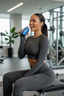 Woman in gray athletic wear holding a water bottle in a gym setting