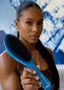 Woman holding a blue hairbrush with a blurred background