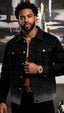 Man wearing a black studded jacket with a blurred abstract painting in the background