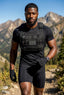 Man in tactical gear standing in a mountainous landscape