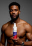 Man holding a bottle of SuStylen hair product against a gray background