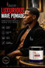 A promotional product image for SPI Styles Luxurious Wave Pomade. A man in a black robe is shown in a luxurious interior setting, with a jar of the pomade displayed in the foreground on a gold table.