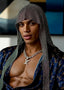Man wearing a patterned headscarf and Louis Vuitton jewelry against a blurred background
