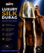 A shirtless male model wearing a shiny gold silk durag with an attached hood, posed against a dark blue promotional background with large text reading 'Luxury Silk Durag' and feature callouts from SPI Styles.