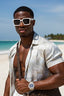 Man wearing sunglasses and a white shirt on a beach