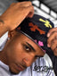 Black velvet durag embellished with artistic multicolor crosses, offering both functionality and bold design