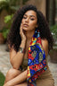 Woman with a colorful scarf draped over her shoulder in an outdoor setting
