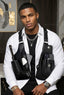 Man wearing a black tactical vest with multiple pockets and compartments.